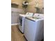 A well-organized laundry room equipped with washer, dryer, and shelving at 310 Warm Springs Cir, Roswell, GA 30075