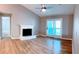 Spacious living room with fireplace, ceiling fan, and access to outdoor balcony at 310 Warm Springs Cir, Roswell, GA 30075