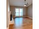 Bright living room with fireplace, ceiling fan and sliding glass doors at 310 Warm Springs Cir, Roswell, GA 30075