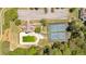A tranquil aerial view showcases a pool, tennis courts, and a community area for relaxation and recreation at 4309 Milford Pl, Hoschton, GA 30548