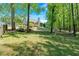 Exterior view of home showcasing spacious backyard and beautiful deck at 4309 Milford Pl, Hoschton, GA 30548