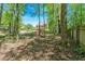Exterior view of backyard with a wooden fence and mature trees at 4309 Milford Pl, Hoschton, GA 30548