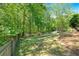 Fenced backyard with mature trees creating a private outdoor space at 4309 Milford Pl, Hoschton, GA 30548