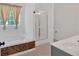 Bright bathroom showcasing a soaking tub with decorative tile and glass shower at 4309 Milford Pl, Hoschton, GA 30548