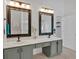 Bathroom featuring double sinks, framed mirrors, and gray cabinetry at 4309 Milford Pl, Hoschton, GA 30548