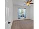 Bright bedroom featuring neutral carpet, and a window offering outdoor views at 4309 Milford Pl, Hoschton, GA 30548
