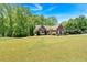 Spacious front lawn showcasing a brick home with manicured landscaping and a welcoming ambiance at 4309 Milford Pl, Hoschton, GA 30548