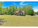Charming home with lush front lawn, surrounded by mature trees offering privacy and curb appeal at 4309 Milford Pl, Hoschton, GA 30548