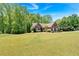 Beautiful, spacious home with lush green lawn, mature trees, and manicured landscaping at 4309 Milford Pl, Hoschton, GA 30548