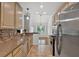 Kitchen with granite countertops, mosaic backsplash, stainless steel appliances, neutral-toned cabinetry, and backyard view at 4309 Milford Pl, Hoschton, GA 30548