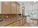 Kitchen with granite countertops, mosaic backsplash, stainless steel appliances, neutral-toned cabinetry, and backyard view at 4309 Milford Pl, Hoschton, GA 30548