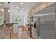 Kitchen with granite countertops, mosaic backsplash, stainless steel appliances, neutral-toned cabinetry, and backyard view at 4309 Milford Pl, Hoschton, GA 30548