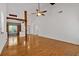 Bright living room featuring hardwood floors, vaulted ceilings, and a decorative wooden beam detail above a doorway at 4309 Milford Pl, Hoschton, GA 30548