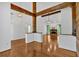 Open-concept living area showcasing hardwood floors, timber beams, and a stone fireplace at 4309 Milford Pl, Hoschton, GA 30548