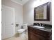 Bathroom features a classic vanity with a black countertop and traditional fixtures at 5737 Russell Ct, Douglasville, GA 30135