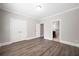 Bedroom showcasing hardwood floors, neutral paint, base trim, and closet access at 5737 Russell Ct, Douglasville, GA 30135