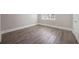 Bedroom featuring hardwood floors, large window and white trim at 5737 Russell Ct, Douglasville, GA 30135