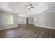 Bedroom with neutral paint, hardwood floors, tray ceiling, and access to other rooms at 5737 Russell Ct, Douglasville, GA 30135
