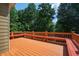 Expansive wooden deck perfect for outdoor enjoyment with built-in seating and surrounded by lush greenery at 5737 Russell Ct, Douglasville, GA 30135