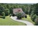 Beautiful two-story home with a stone facade and a large, curved driveway at 5737 Russell Ct, Douglasville, GA 30135