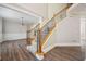 Elegant foyer with hardwood floors, staircase, and decorative chandelier at 5737 Russell Ct, Douglasville, GA 30135