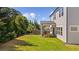 Large grassy backyard with a covered patio, perfect for outdoor relaxation and entertaining at 6070 Arbor Green Cir, Sugar Hill, GA 30518