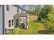Spacious backyard featuring a covered patio, lush lawn, and privacy with mature trees at 6070 Arbor Green Cir, Sugar Hill, GA 30518