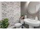 Charming powder room with elegant wallpaper, pedestal sink, and stylish fixtures creating a luxurious feel at 6070 Arbor Green Cir, Sugar Hill, GA 30518