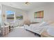 Bright bedroom with soft carpet, large bed, and a window offering natural light for a cozy retreat at 6070 Arbor Green Cir, Sugar Hill, GA 30518