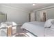 This is a bedroom with light gray walls and carpet, white crown molding, and is well illuminated by a light fixture at 6070 Arbor Green Cir, Sugar Hill, GA 30518