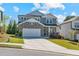 Attractive two-story home featuring stone accents, a front-facing garage, and a landscaped lawn at 6070 Arbor Green Cir, Sugar Hill, GA 30518