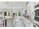 Bright kitchen featuring granite countertops, island with breakfast bar, and modern stainless steel appliances at 6070 Arbor Green Cir, Sugar Hill, GA 30518