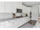 Kitchen with updated granite counters, white cabinets, and stainless appliances at 6070 Arbor Green Cir, Sugar Hill, GA 30518