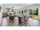 Open-concept living room featuring a fireplace, hardwood floors, and access to the outdoor patio at 6070 Arbor Green Cir, Sugar Hill, GA 30518