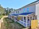 Row of townhomes featuring covered patios, fenced yards, and professionally landscaped lawns at 1207 Fern Ridge Ct # 15, Norcross, GA 30093
