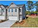 Charming, newly built townhome with a two-car garage, neutral color palette, and fresh landscaping at 1207 Fern Ridge Ct # 15, Norcross, GA 30093