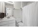 Bathroom featuring a vanity, toilet, shower with curtain, and natural lighting at 1723 Highlands Se Vw, Smyrna, GA 30082