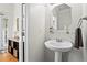 Clean and modern half-bath with pedestal sink and hardwood flooring at 1723 Highlands Se Vw, Smyrna, GA 30082