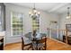 Charming dining area with large windows offering views of the surrounding greenery, and a decorative chandelier at 1723 Highlands Se Vw, Smyrna, GA 30082