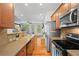 Open kitchen flows to living area, stainless appliances, granite counters, hardwood floors at 1723 Highlands Se Vw, Smyrna, GA 30082