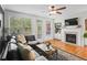 Bright living room features hardwood floors, fireplace, built-in bookcases, and a ceiling fan at 1723 Highlands Se Vw, Smyrna, GA 30082