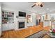 Spacious living room with hardwood floors, fireplace, and built-in bookshelves, and an open floor plan at 1723 Highlands Se Vw, Smyrna, GA 30082