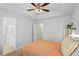 Bright main bedroom featuring a ceiling fan, tray ceiling, and doorway leading to the main bathroom at 1723 Highlands Se Vw, Smyrna, GA 30082