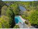 Aerial view of community pool surrounded by lush greenery and scenic lake views at 1723 Highlands Se Vw, Smyrna, GA 30082