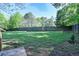 Expansive backyard is enclosed by a tall wooden fence, offering privacy and security at 20 Old Oak Ct, Covington, GA 30016