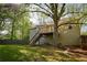 Backyard features a patio, deck, and steps down to the yard, all under the shade of mature trees at 20 Old Oak Ct, Covington, GA 30016