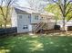 This home has a spacious backyard with a wooden fence, deck, and mature trees at 20 Old Oak Ct, Covington, GA 30016