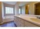 Bathroom featuring double sinks, a garden tub, and plenty of natural light at 20 Old Oak Ct, Covington, GA 30016