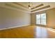 Spacious bedroom with tray ceiling, natural light, and hardwood flooring at 20 Old Oak Ct, Covington, GA 30016