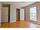 A bright bedroom features hardwood floors and neutral paint colors to create a comfortable living space at 20 Old Oak Ct, Covington, GA 30016